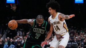 Boston Celtics guard Jaylen Brown (7) drives to the basket against New Orleans Pelicans guard Micah Peavy (14) during the second half of an NBA basketball game, Friday, April 10, 2026, in Boston. (AP Photo/Charles Krupa)